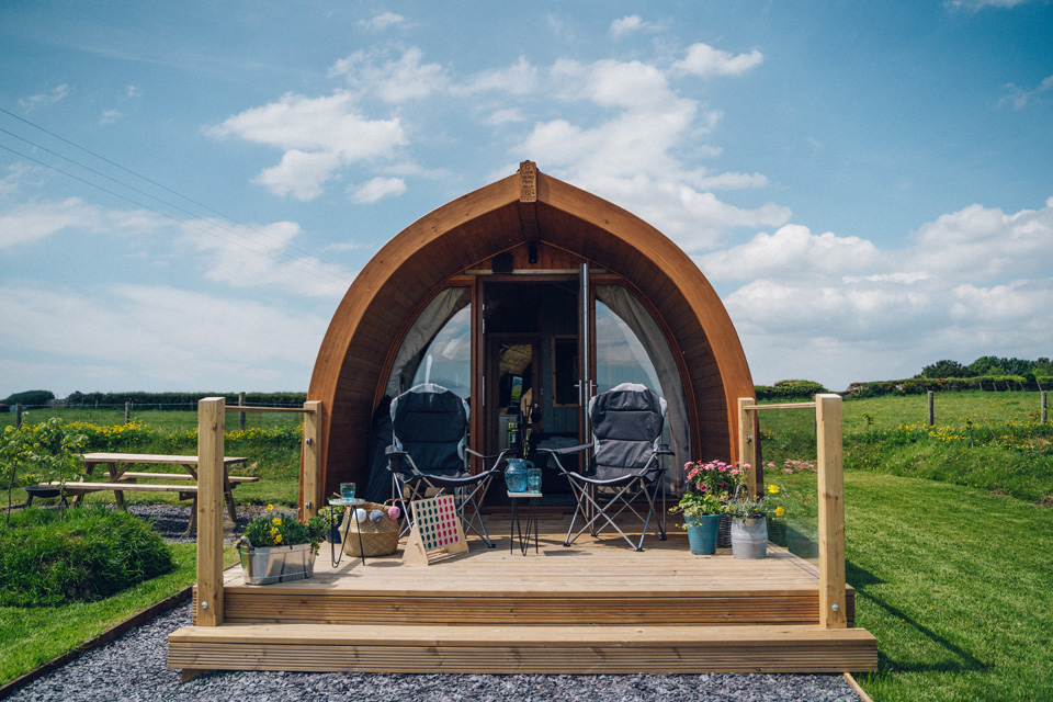 outside of a pod with camping chairs and flowers