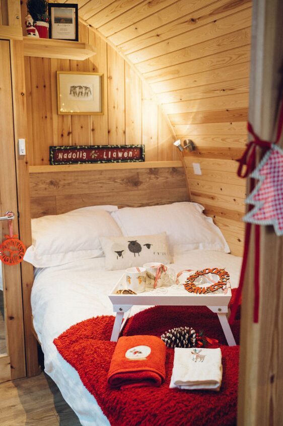 christmas hamper on a bed next to towels