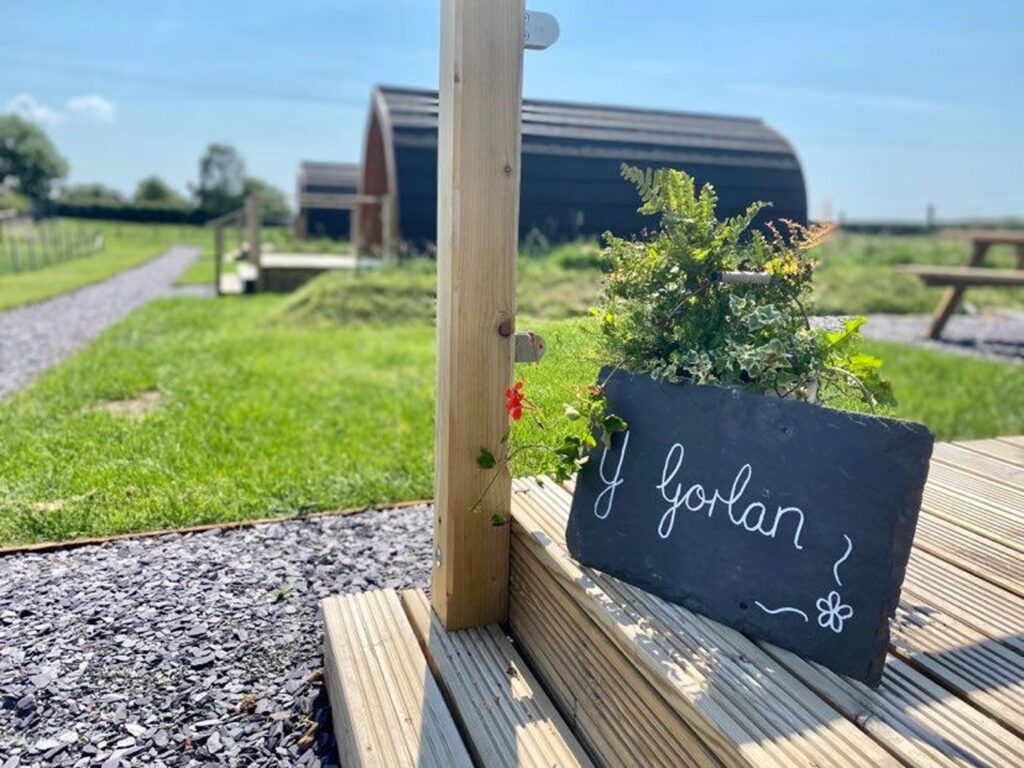 slate outside a pod with y gorlan written on it